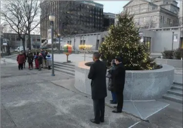  ?? PHOTOS BY GENE WALSH — DIGITAL FIRST MEDIA ?? County commission­ers watch as a tree, a menorah and a kinara are lighted in Norristown Dec. 5.