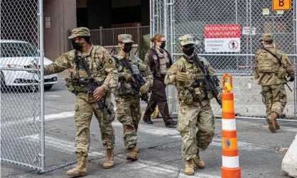  ?? Photograph: Kerem Yucel/AFP/Getty Images ?? Members of the national guard open a security gate outside the Hennepin county government center on March 9, 2021 in Minneapoli­s, Minnesota.