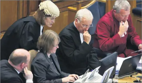  ??  ?? TENSE TIMES: The Kirk’s Procurator Laura Dunlop with the Clerks at the General Assembly in Edinburgh during the debate on gay clergy yesterday. Picture: Gordon Terris