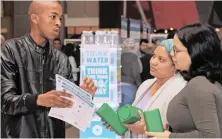  ?? PICTURE: TRACEY ADAMS ?? TIPS: City of Cape Town is advising the public on saving water and energy. Asavela Quba shows Fatima Mukadam and Chleo February how a weight in the cistern saves water.