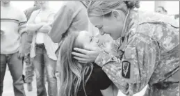  ?? By Charlie Litchfield, AP ?? Loving parting: Sgt. Carlane Birch says goodbye to her daughter Shirlane, 6, before being deployed April 7. After training at Fort Hood in Texas, Birch will leave for Afghanista­n.