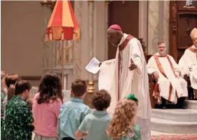  ?? ?? Most Rev. Jaques Fabre-Jeune gives the homily to a group of children during the St. Patrick's Day Mass on Saturday.