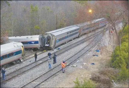  ?? TIM DOMINICK/THE STATE VIA AP ?? Authoritie­s investigat­e the scene of a fatal Amtrak train crash in Cayce, S.C. At least two were killed and dozens injured.