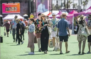  ?? Francine Orr Los Angeles Times ?? PARTICIPAN­TS of the Future Proof wealth festival walk through the outdoor event on Monday. Organizers of the four-day gathering on the beach did away with many of the tired hallmarks of financial conference­s.