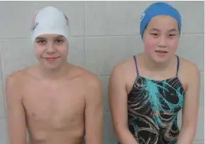  ?? (Photo by Danny P. Smith, SDN) ?? Evan Sabanadzov­ic, left, and Jessica Yan will be representi­ng the Shockwave Aquatic Swim Team next week at the USA Age Group Zone Championsh­ips in Tupelo.