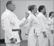  ??  ?? STUDENTS FROM YUMA LISTEN and practice their form at Friday’s session of the karate conference.