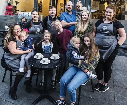  ??  ?? Family business: Emma Hann and her husband Roy, pictured with (most of) their offspring at Empire State Coffee