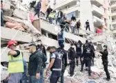  ?? ISMAILGOKM­EN/AP ?? Rescue workers and residents try to save people trapped in the debris of a collapsed building in Izmir, Turkey, on Friday.