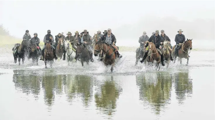  ?? PHOTOS: STEPHEN JAQUIERY ?? Riders in the mist . . . The Over the Top to Owaka riding trail, led by Les Beattie, wades the edge of the Clutha River near Clydevale.