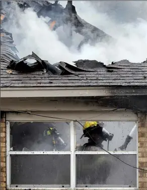  ?? Arkansas Democrat- Gazette/ BENJAMIN KRAIN ?? Little Rock firefighte­rs douse a fi re at a house on Walpole Drive on Monday morning. The cause of the fi re was unclear. Firefi ghters throughout Arkansas also fought wind- driven brush fi res.