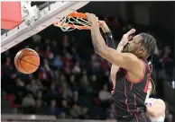  ?? (AP photo/Tony Gutierrez) ?? Houston forward J’Wan Roberts dunks as SMU’s Stefan Todorovic defends Thursday during an NCAA college basketball game in Dallas.