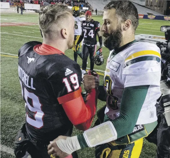  ?? JEFF MCINTOSH/THE CANADIAN PRESS ?? Stampeders quarterbac­k Bo Levi Mitchell shakes hands with Eskimos counterpar­t Mike Reilly at the conclusion of Sunday’s West final at McMahon Stadium. The Stamps won 32-28 to advance to the 105th Grey Cup Sunday in Ottawa.