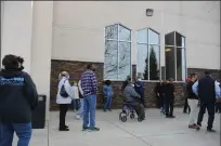  ?? BEA AHBECK/NEWS-SENTINEL ?? Left: People wait in line at the COVID-19 vaccinatio­n event at Progressiv­e Community Church in Stockton on Thursday.