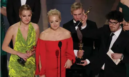  ?? Photograph: Carlos Barría/Reuters ?? Yulia Navalnya (second left), wife of jailed dissident Alexei Navalny, speaks next to her daughter Daria (far left) and director Daniel Roher (far right) after Navalny won the Academy Award for best feature documentar­y.