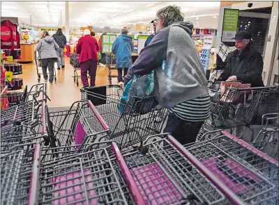  ?? SEAN D. ELLIOT THE DAY ?? Customers head into Stop & Shop in Norwich early Thursday for special shopping hours for older customers.