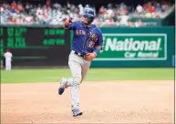  ?? Nick Wass / Associated Press ?? The Mets’ Javier Baez points to the stands as he rounds the bases on his home run during the third inning against the Nationals on Sunday in Washington.