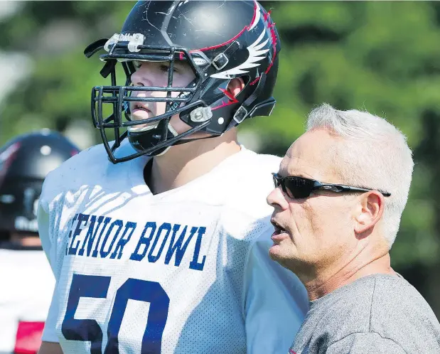  ?? GERRY KAHRMANN/PNG ?? Terry Fox Ravens offensive lineman Matt Hewa Baddege and coach Martin McDonnell believe the Port Coquitlam football squad has the talent in place to contend for a provincial triple-A title even with four top players being recruited south of the border.