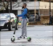  ?? ALYSSA POINTER / ALYSSA.POINTER@AJC.COM ?? Metro Atlanta communitie­s are struggling to control electric scooters and bikes, which critics say endanger their riders, pedestrian­s and others. Supporters say they’re great for short trips.