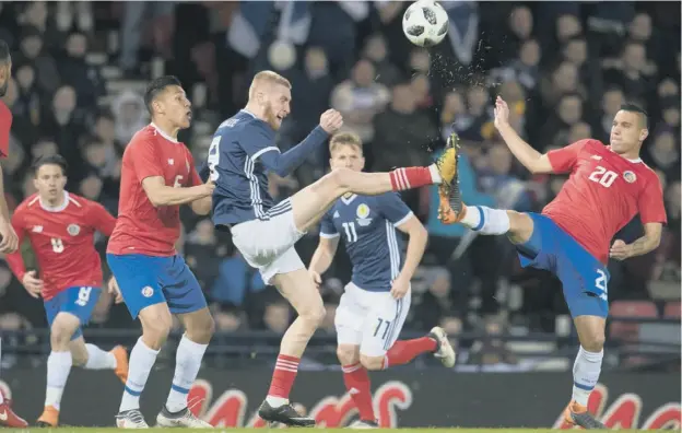  ??  ?? Scotland debutant Oli Mcburnie, left, competes with Costa Rica’s David Guzman during the Central American side’s 1-0 victory in the friendly at Hampden last night.