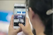  ??  ?? A supporter uses her phone to snap a photo of Prime Minister Stephen Harper earlier this week. Experts say social media will affect the federal election campaign.