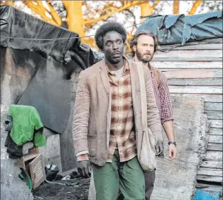  ?? Marcos Cruz Netflix ?? Michael Kenneth Williams, left, and Chris Evans in a scene from “The Red Sea Diving Resort.”