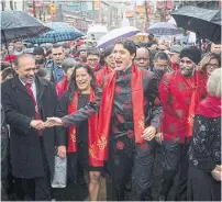  ?? DARRYL DYCK THE CANADIAN PRESS ?? Prime Minister Justin Trudeau is flanked by former justice minister Jody Wilson-Raybould and Defence Minister Harjit Sajjan at Vancouver’s Chinese New Year parade in 2017.