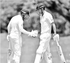  ??  ?? England openerAlas­tair Cook (R) celebrates his 50 against CricketAus­tralia XI with batting partner Mark Stoneman (L) on the second day of a four-day Ashes tour match at the Tony Ireland Stadium in Townsville on November 16, 2017. - AFP photo