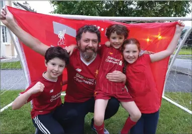  ??  ?? Reds supporters Conor, Harry and Anna Mai Hughes celebratin­g with dad, Kerryman Editor Kevin.
