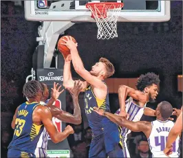  ??  ?? Indiana Pacers player Domantas Sabonis (C) tries to shoot the ball during the first pre-season NBA basketball game against Sacramento Kings at the NSCI Dome in Mumbai on Friday