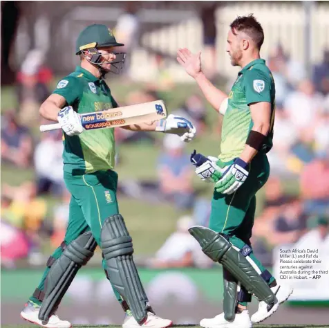  ??  ?? South Africa’s David Miller (L) and Faf du Plessis celebrate their centuries against Australia during the third ODI in Hobart. — AFP