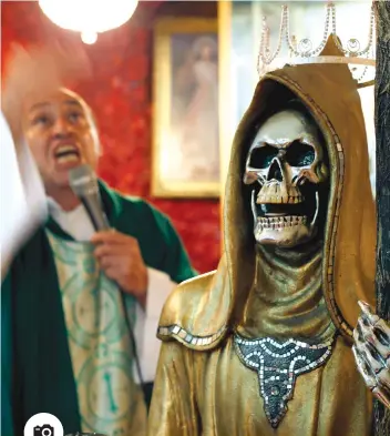  ?? AP FOTO ?? DEATH SAINT. A statue of the Death Saint stands inside Mercy Church as Juan Carlos Avila Mercado gives a service, on the edge of Mexico City’s Tepito neighborho­od. “She chooses them and has always been with us,” said Avila, who says he is a Catholic...