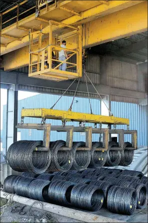  ?? NWA Democrat-Gazette/DAVID GOTTSCHALK ?? An overhead crane system is used to unload wire rod coils at Five Rivers Distributi­on in Van Buren.