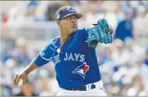  ?? Associated Press photo ?? Toronto Blue Jays starting pitcher Marcus Stroman goes into his windup during the first inning of a spring training baseball game against the Tampa Bay Rays Sunday in Dunedin, Fla.