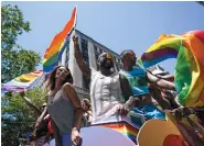  ?? MARY ALTAFFER/THE ASSOCIATED PRESS) ?? One (10th of 18) Caption: Revelers parade down Fifth Avenue during the annual Pride March in New York on Sunday.