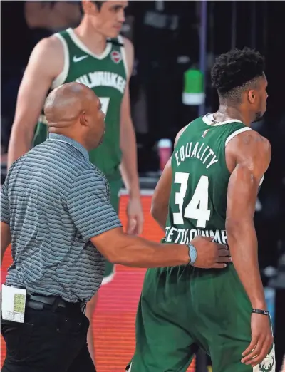  ??  ?? The Bucks' Giannis Antetokoun­mpo (34) heads to the locker room after being ejected from Tuesday's game.