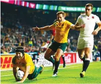  ??  ?? Pool of Death: Matt Giteau goes over to score Australia’s third try as they beat England in 2015