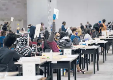  ?? NICOLECRAI­NE/THENEWYORK­TIMES ?? Workers recount election ballots by hand Saturday at the GeorgiaWor­ld CongressCe­nter inAtlanta.