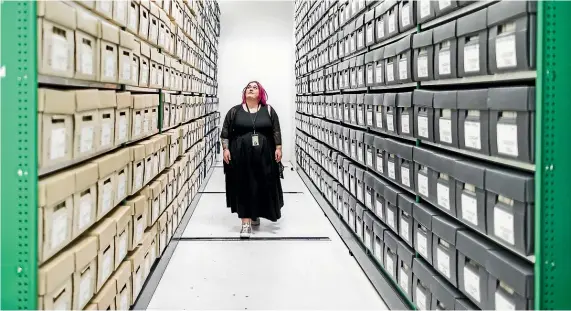  ?? ROSA WOODS/STUFF ?? Archives access specialist Georgia Mackay with some of the paper records in the Wellington City Council Archives that are being digitised.