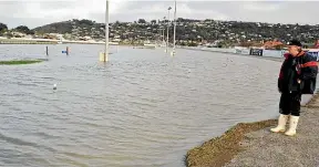  ??  ?? Track manager Ken McFarlane surveys flooding on the northern bend at Forbury Park Raceway in June 2015.