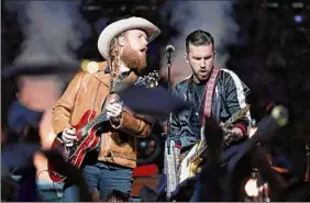  ?? Rick Osentoski / Associated Press ?? John Osborne, left, and T.J. Osborne of the Brothers Osborne musical duo perform during halftime of an NFL football game between the Detroit Lions and the Chicago Bears on Nov. 28, 2019, in Detroit.