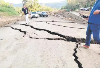  ?? ?? Cracks are seen on a section of road near Berikau, Lawas, which is believed caused by soil movement.