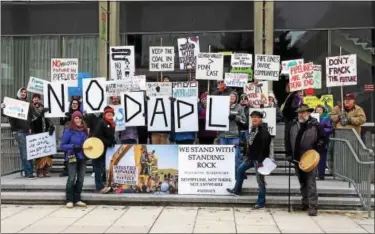  ?? SUBMITTED PHOTO - ALL RIGHTS RESERVED TO TAYLOR ECKER OF TAYPAC PHOTOGRAPH­Y ?? Protestors gathered at the plaza next to the Bethlehem Public Library on Sunday, Dec. 11, calling on the federal government to permanentl­y block constructi­on of the controvers­ial Dakota Access Pipeline.