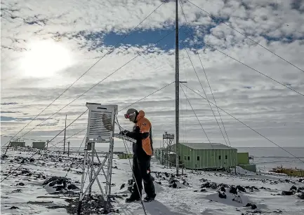  ?? PHOTO: IAIN MCGREGOR/STUFF ?? A scientist taking weather readings at Scott Base, which has been happening at 9am since 1957.