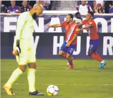  ?? Mike Lawrie / Getty Images ?? To the dismay of U.S. goalkeeper Tim Howard, Marco Ureña (center) celebrates his second goal with Johan Venegas.