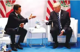  ??  ?? HAMBURG: In this July 7, 2017 file photo, US President Donald Trump meets with Mexican President Enrique Pena Nieto at the G20 Summit, in Hamburg. Trump’s push to renegotiat­e the North American Free Trade Agreement is putting Mexico in a tough spot,...