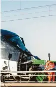  ??  ?? Rettungskr­äfte am schwer beschädigt­en Personenzu­g.