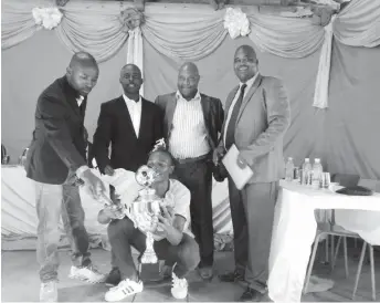  ??  ?? Godlwayo South Soccer League Player of the Year Christophe­r Siziba (kneeling) with (from left) Zibusiso Majankwe Ncube, Kossam Mavuna Ndlovu, Madinda Ndlovu and Bhekimpilo Maranda Sithole after collecting his trophy at last year’s awards ceremony