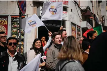  ?? ?? Chega far-right party supporters wave flags during a rally in Lisbon’s Graca neighbourh­ood.