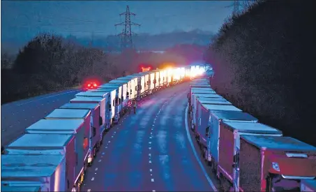  ?? REUTERS ?? Lorries queue up on the M20 motorway near Ashford, Britain, after EU countries imposed a travel ban from the UK following the outbreak of a new Covid-19 strain.