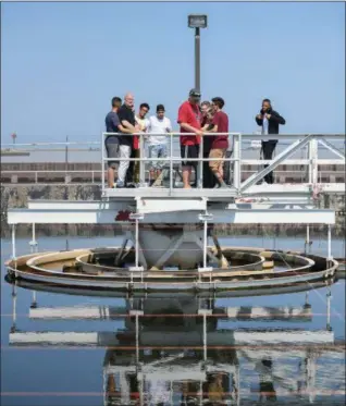  ?? ERIC BONZAR — THE MORNING JOURNAL ?? Teacher John Akosi and a group of Lorain High School environmen­tal science scholars get a tour of the city’s waste water treatment plant from plant assistant superinten­dent Tim Cox on May 29.